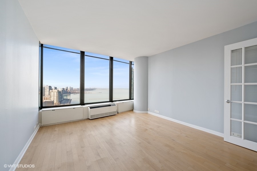 505 North Lake Shore Drive, Unit 4112 Chicago, IL 60611 - Photo 17 of 29 an empty room with sliding door and windows