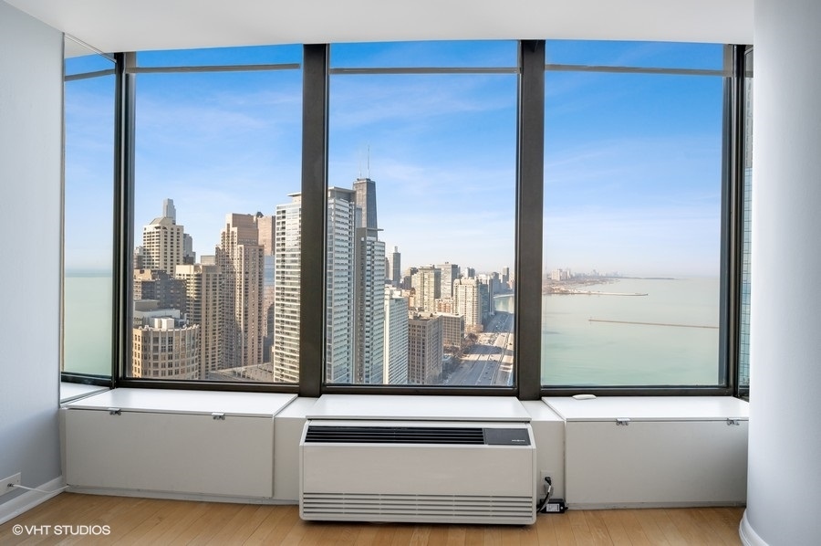 505 North Lake Shore Drive, Unit 4112 Chicago, IL 60611 - Photo 18 of 29 a view of a living room with a large window and floor to ceiling window