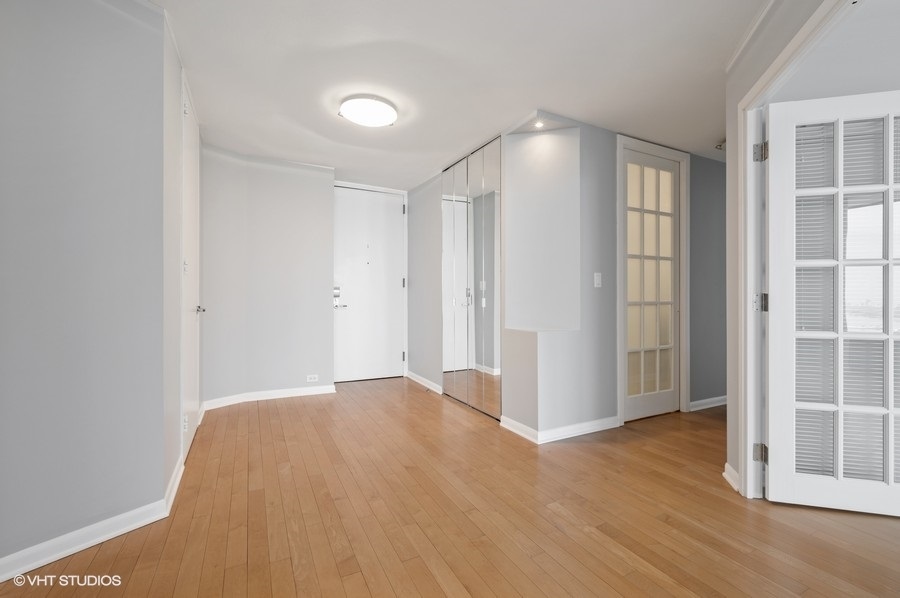 505 North Lake Shore Drive, Unit 4112 Chicago, IL 60611 - Photo 6 of 29 a view of empty room with wooden floor and entryway