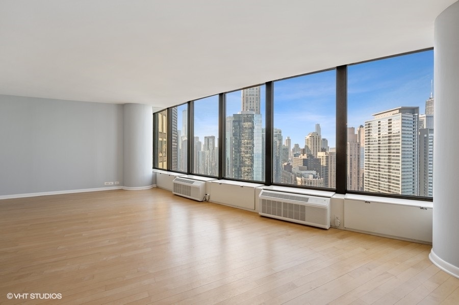 505 North Lake Shore Drive, Unit 4112 Chicago, IL 60611 - Photo 7 of 29 an empty room with floor to ceiling window and an outdoor view