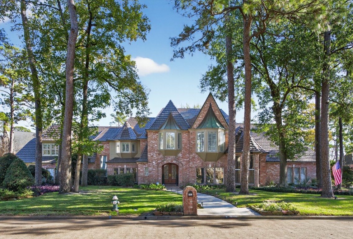a view of a big house in a big yard with large trees