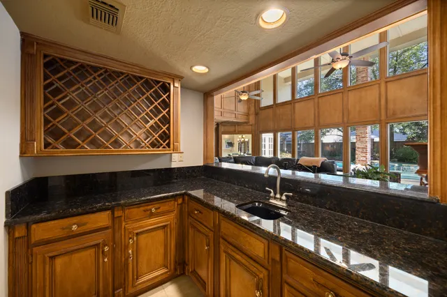 a kitchen with granite countertop a sink and a counter top space