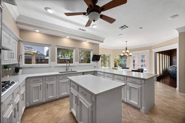 a kitchen with a sink stove and cabinets