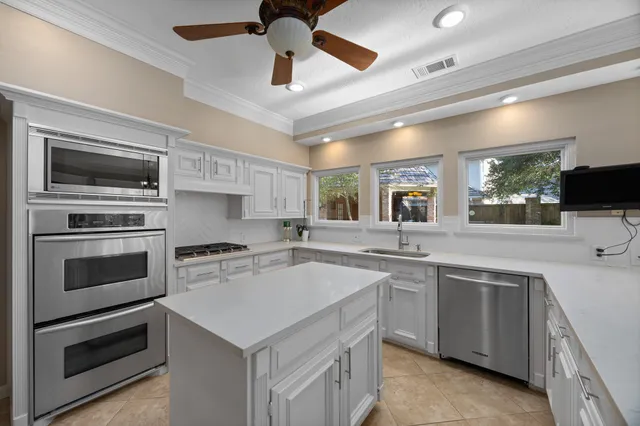 a kitchen with a stove sink and microwave
