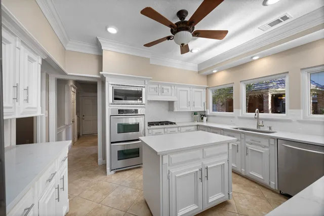 a kitchen with a stove sink and a refrigerator
