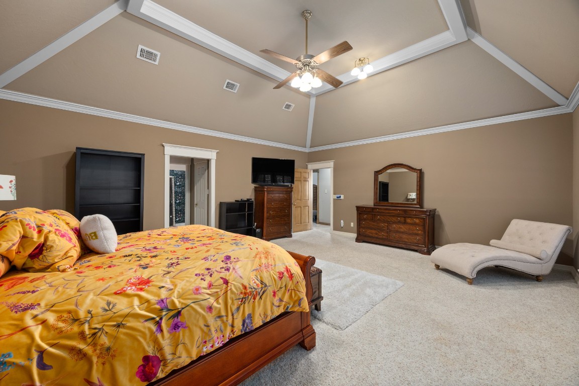 8807 Chelmsford Lane Spring, TX 77379 - Photo 25 of 50 a spacious bedroom with a large bed and a chandelier