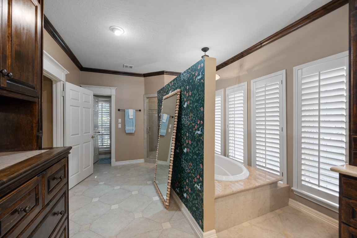 8807 Chelmsford Lane Spring, TX 77379 - Photo 30 of 50 a bathroom with a bathtub and a shower