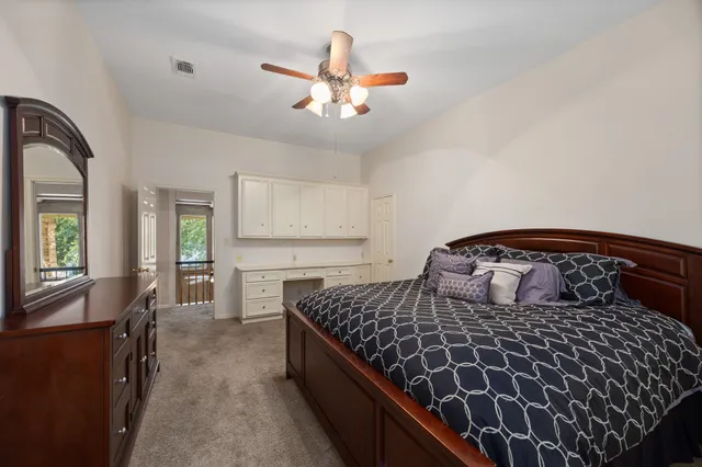 a bedroom with a large bed and a chandelier