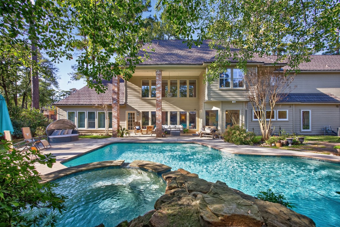8807 Chelmsford Lane Spring, TX 77379 - Photo 44 of 50 a front view of a house with swimming pool having outdoor seating