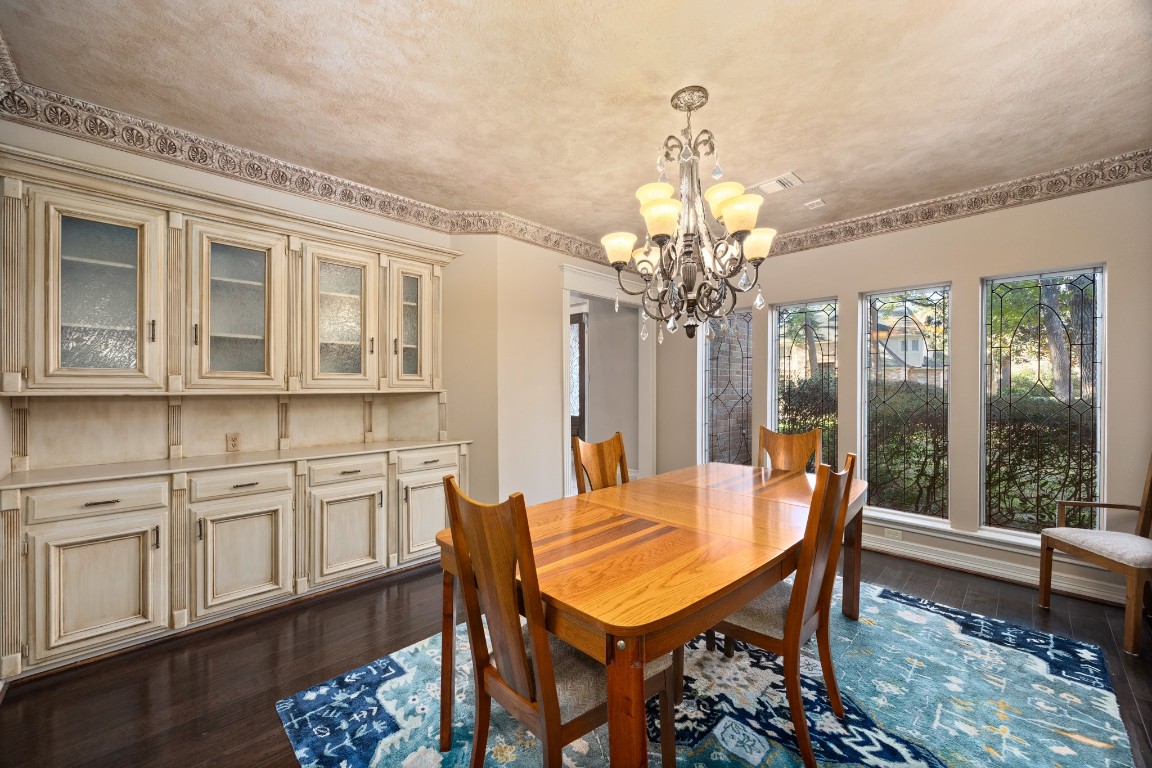 8807 Chelmsford Lane Spring, TX 77379 - Photo 9 of 50 a view of a dining room with furniture a chandelier and wooden floor