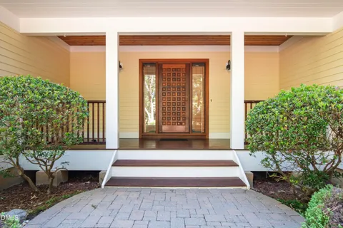 a large kitchen with kitchen island a large counter top stainless steel appliances and cabinets