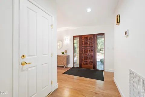 a kitchen with stainless steel appliances granite countertop a sink a stove and a wooden floors