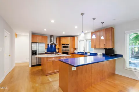 a view of a livingroom with wooden floor and a ceiling fan