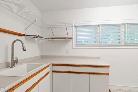 a large bed sitting in a room next to a light fixture