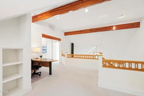 a view of a house with a tree in front of it