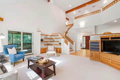 a dining hall with stainless steel appliances granite countertop a sink and a large window