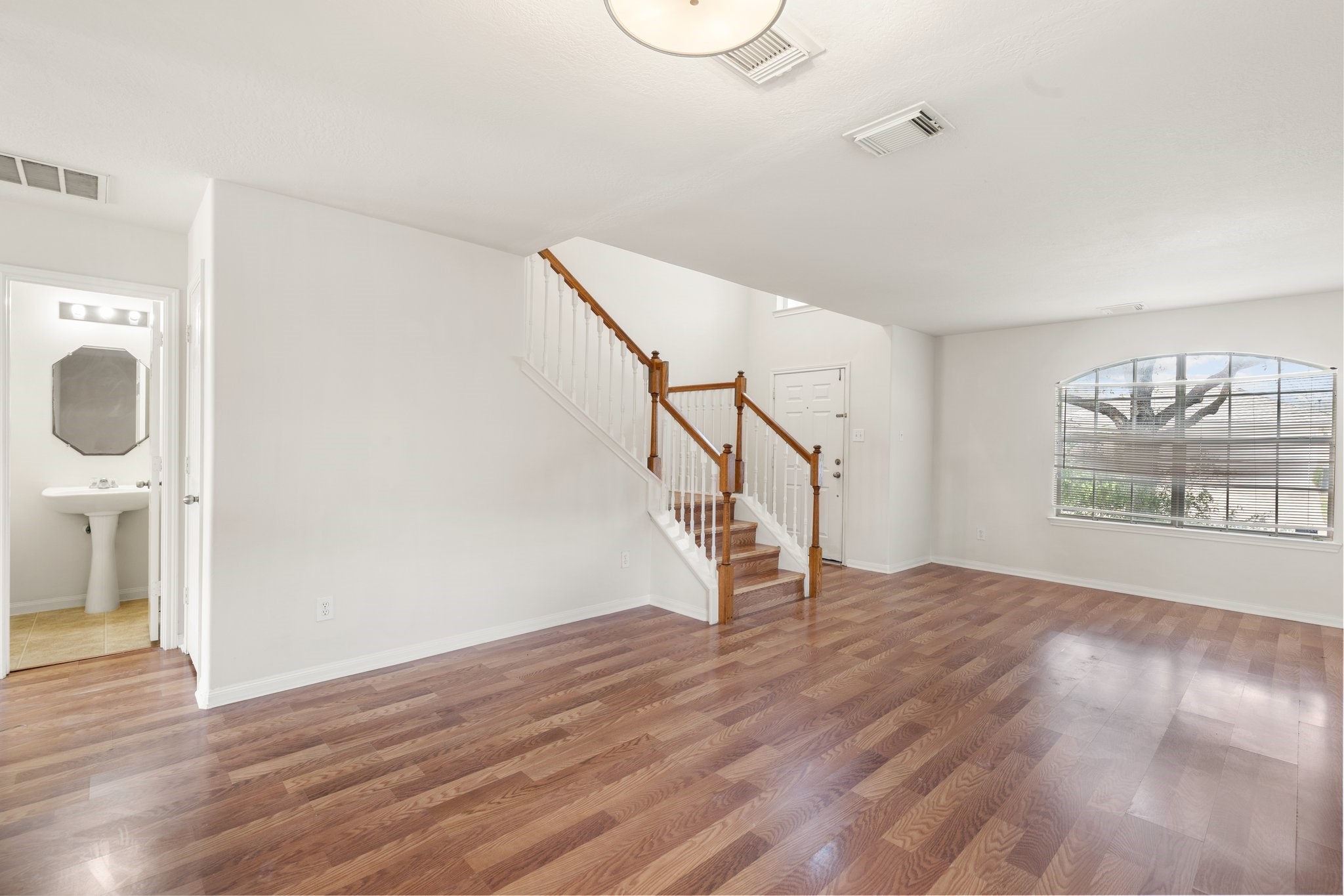 3111 Holly Ranch Drive Katy, TX 77494 - Photo 6 of 28 a view of an empty room with wooden floor and a window