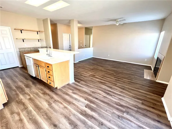 a kitchen with stainless steel appliances wooden floors and view living room