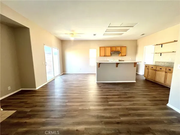 a view of a kitchen with a sink and dishwasher stove top oven with wooden floor