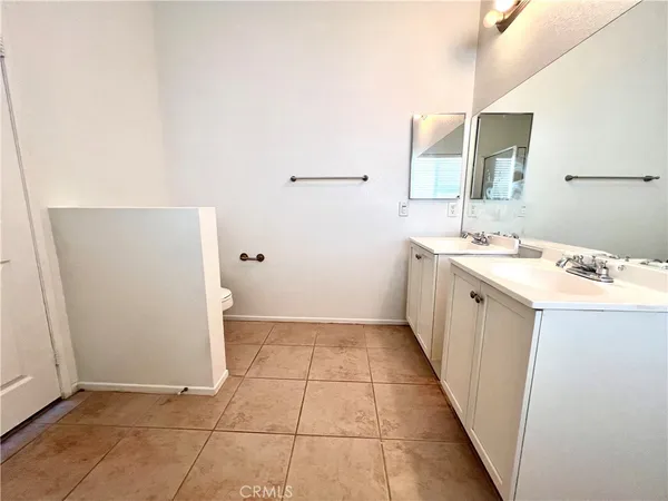 a utility room with a sink a vanity and a mirror