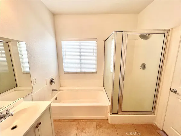 a bathroom with a tub sink and a shower