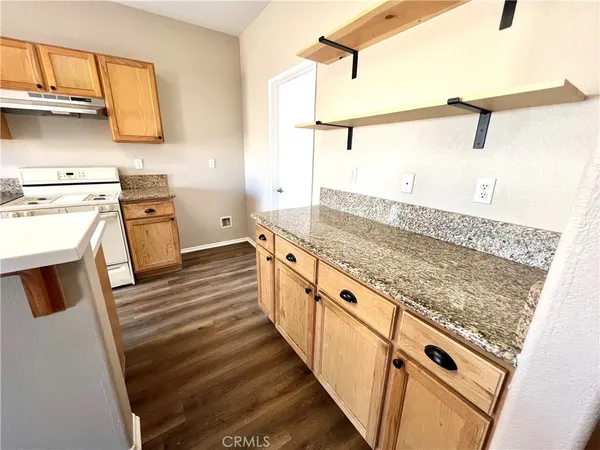 a kitchen with white cabinets and sink