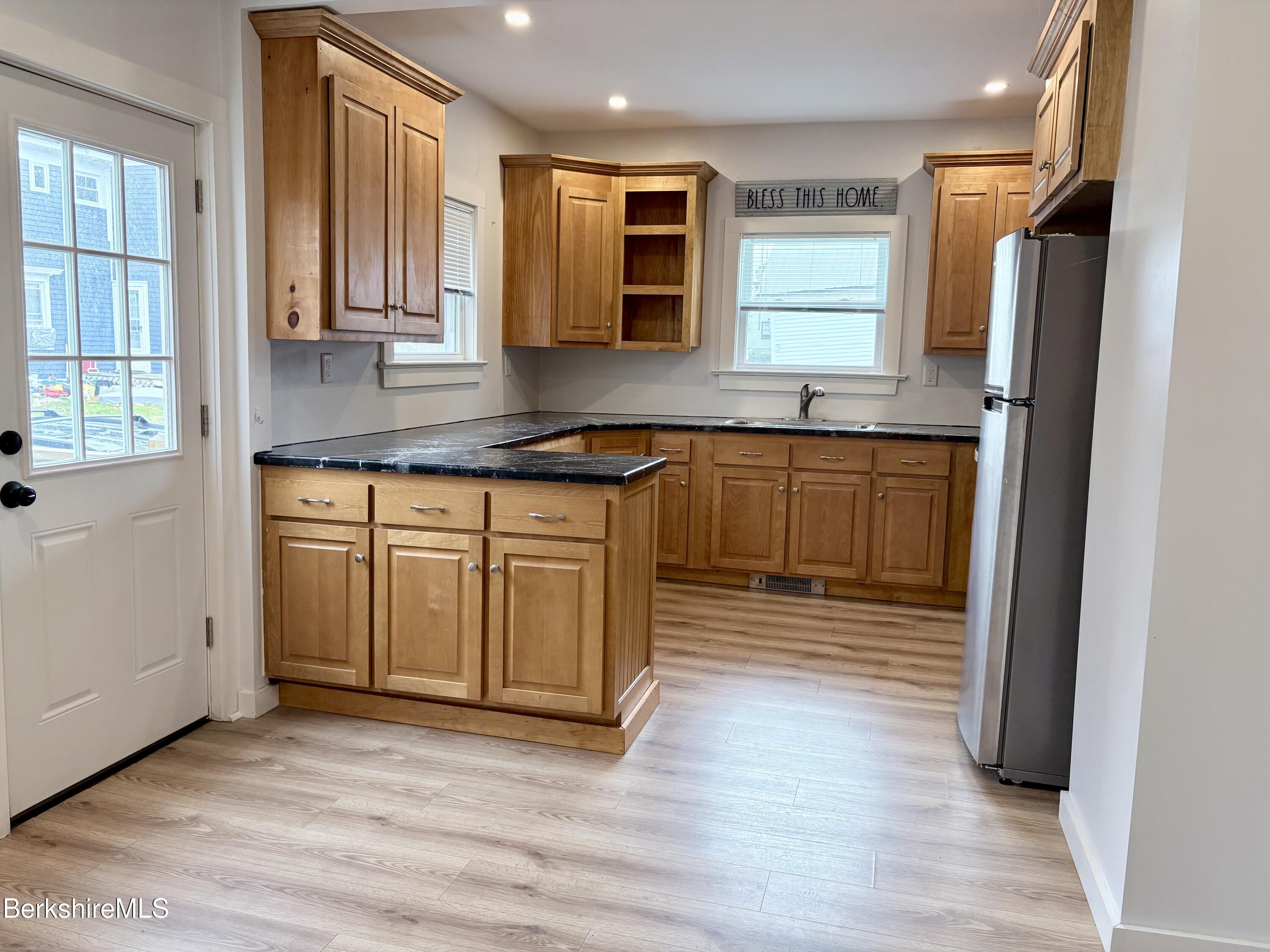 50 Temple Street Adams, MA 01220 - Photo 6 of 13 a kitchen with stainless steel appliances granite countertop a stove a sink and a refrigerator