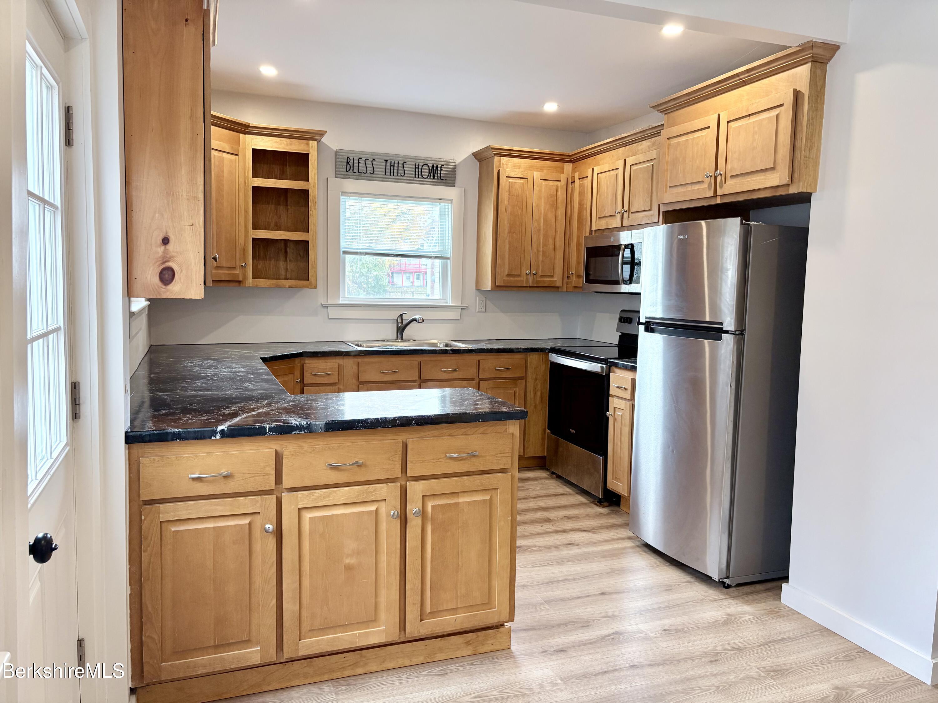 50 Temple Street Adams, MA 01220 - Photo 7 of 13 a kitchen with stainless steel appliances granite countertop a refrigerator sink and cabinets