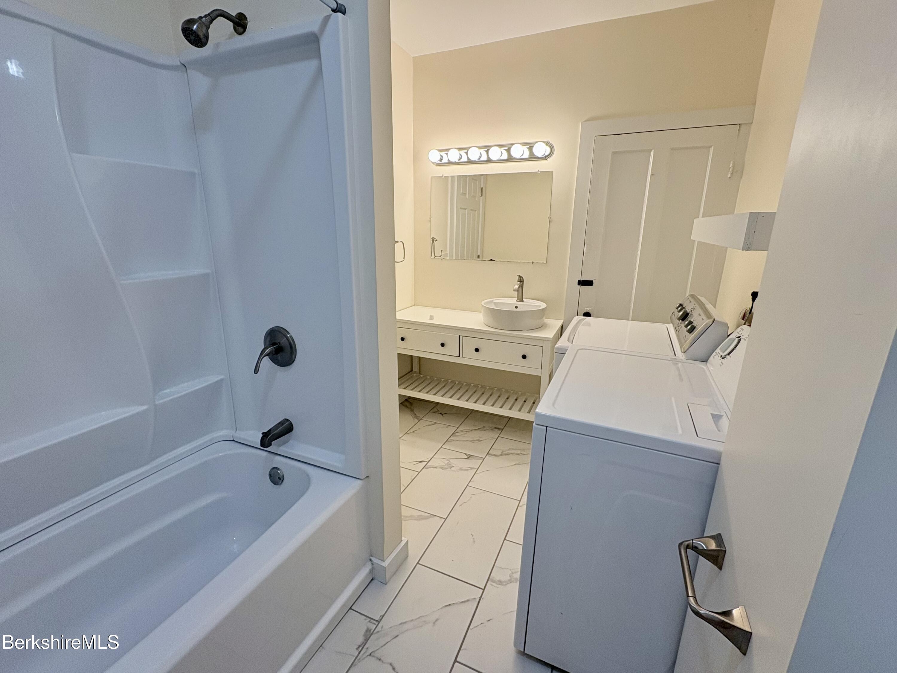 50 Temple Street Adams, MA 01220 - Photo 8 of 13 a bathroom with a tub sink and mirror