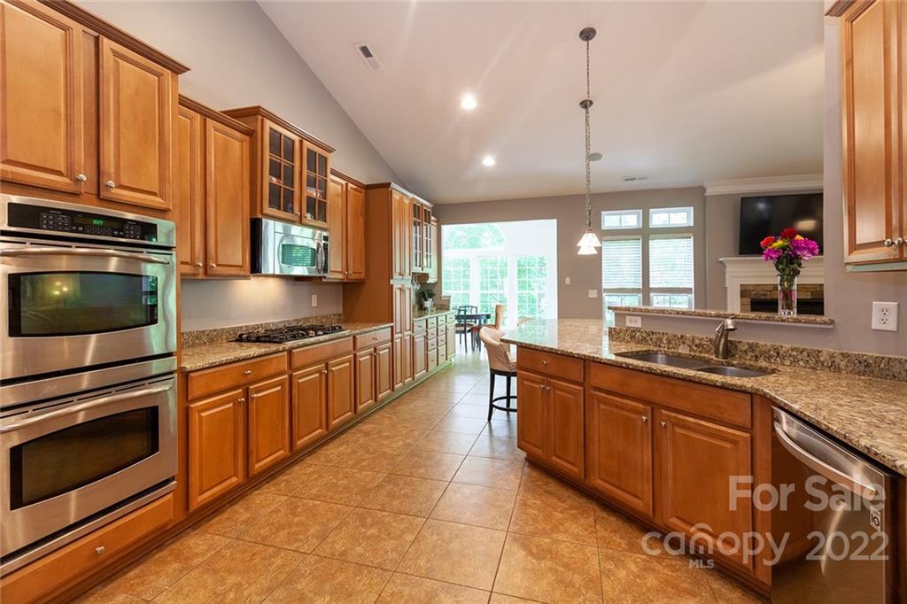 1292 Valhalla Drive Denver, NC 28037 - Photo 15 of 47 a kitchen with stainless steel appliances granite countertop wooden cabinets a sink and dishwasher