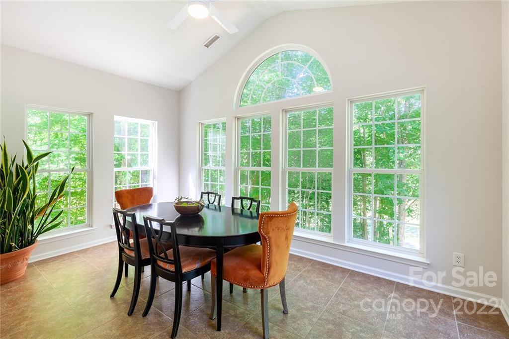 1292 Valhalla Drive Denver, NC 28037 - Photo 16 of 47 a dining room with furniture a rug and a potted plant