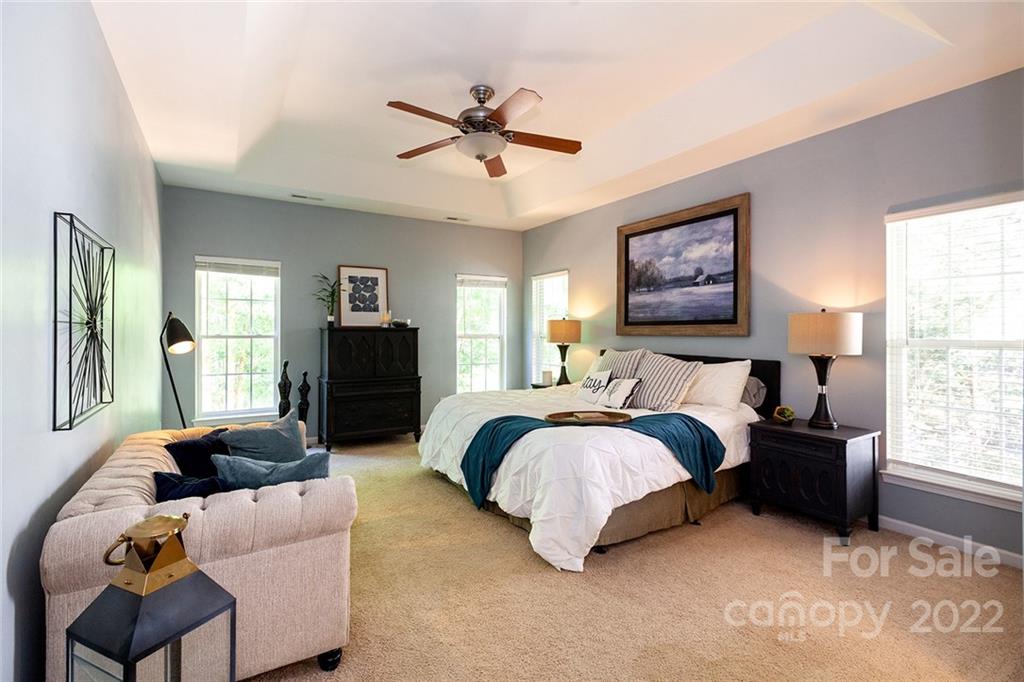 1292 Valhalla Drive Denver, NC 28037 - Photo 19 of 47 a spacious bedroom with a bed couch and windows