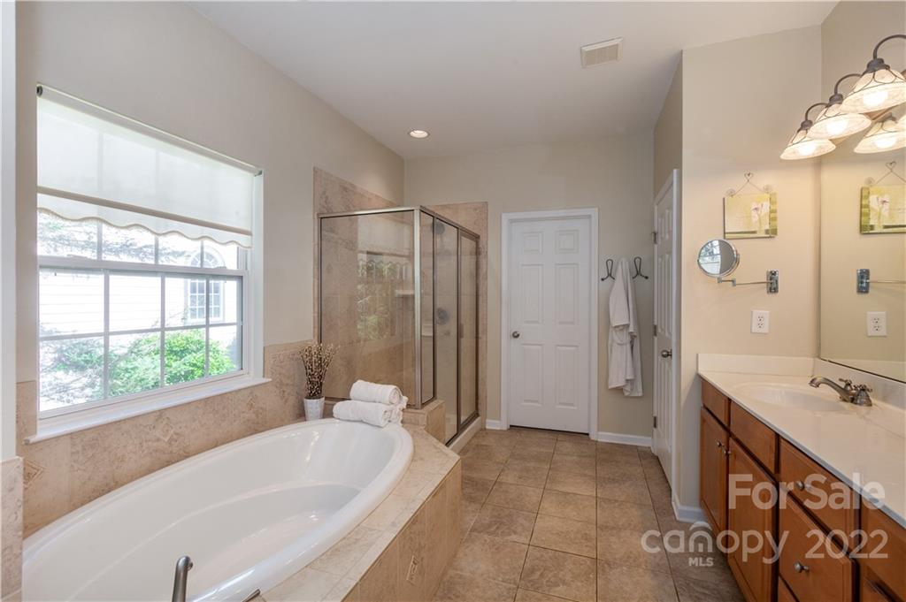 1292 Valhalla Drive Denver, NC 28037 - Photo 21 of 47 a spacious bathroom with a tub sink and mirror