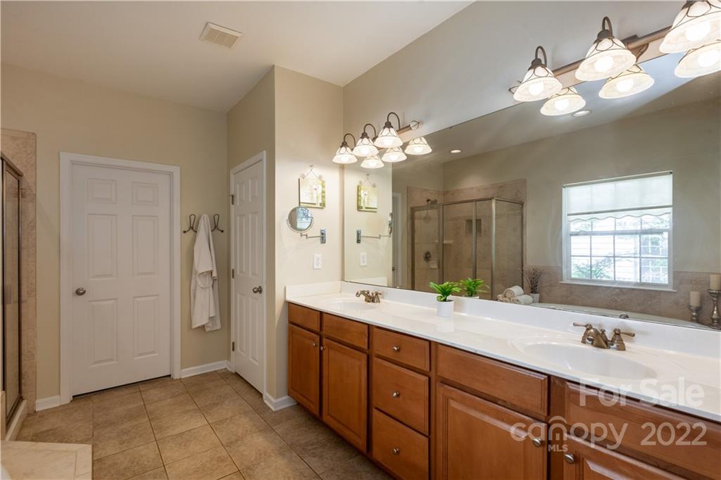 1292 Valhalla Drive Denver, NC 28037 - Photo 23 of 47 a spacious bathroom with a double vanity sink mirror and chandelier