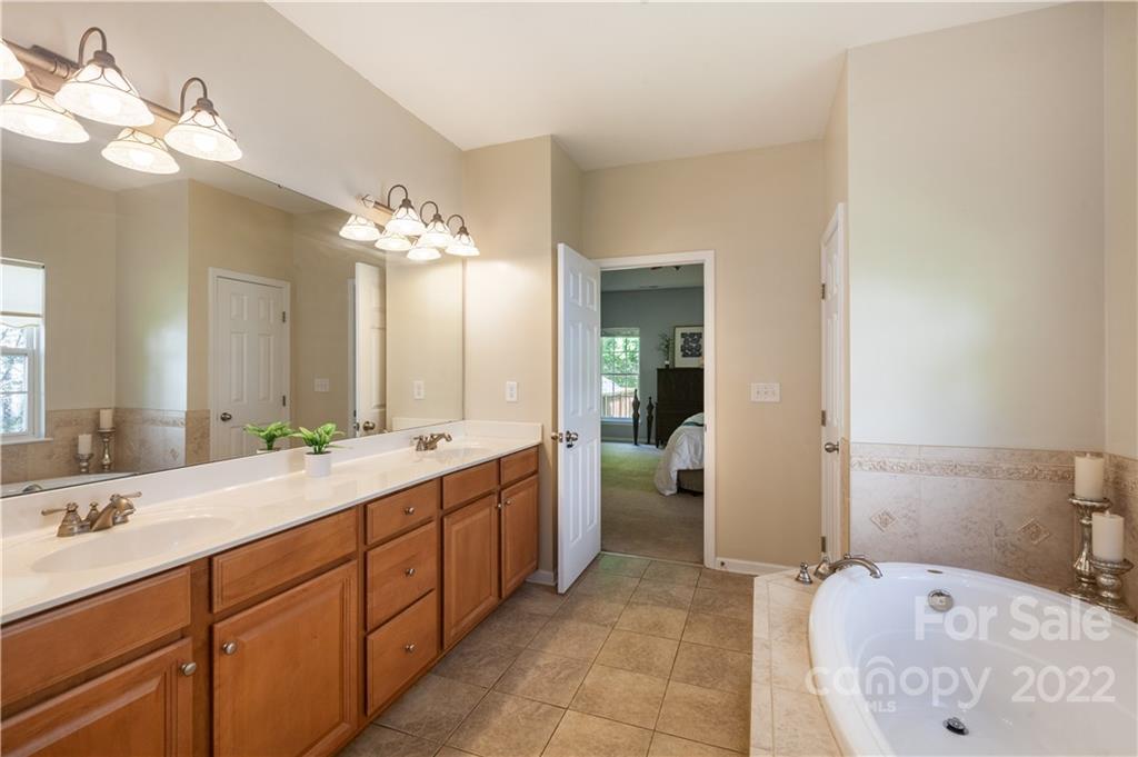 1292 Valhalla Drive Denver, NC 28037 - Photo 24 of 47 a spacious bathroom with a double vanity sink mirror and bathtub