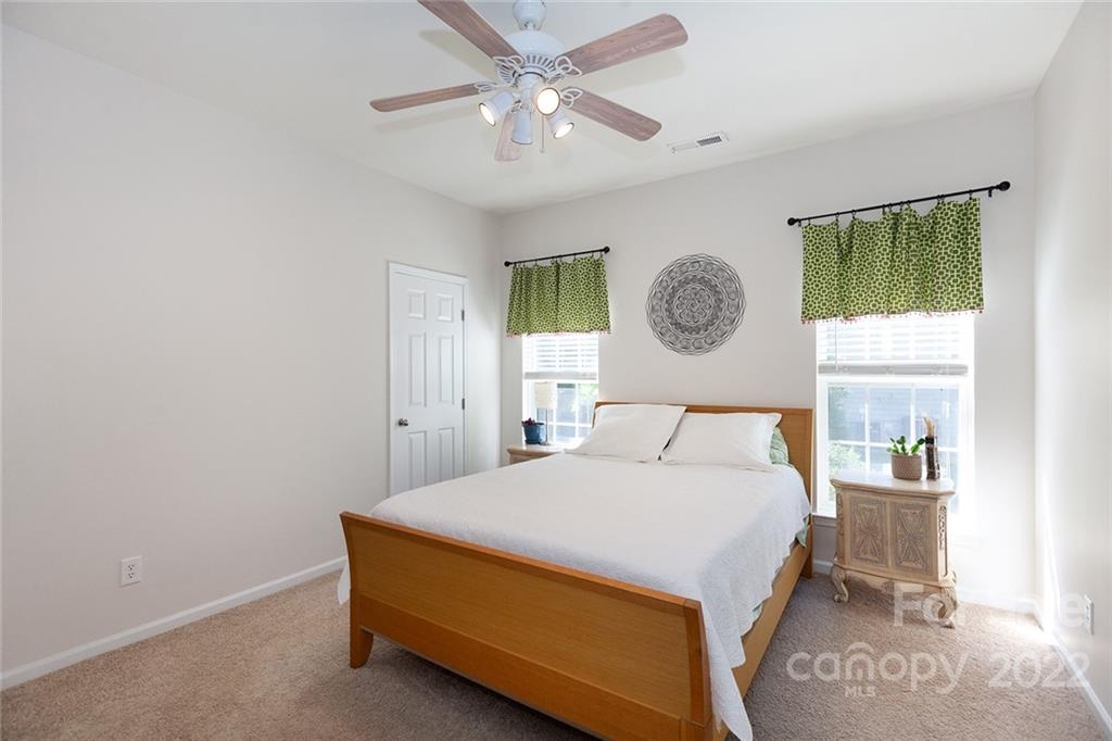 1292 Valhalla Drive Denver, NC 28037 - Photo 31 of 47 a bedroom with a bed and a chandelier