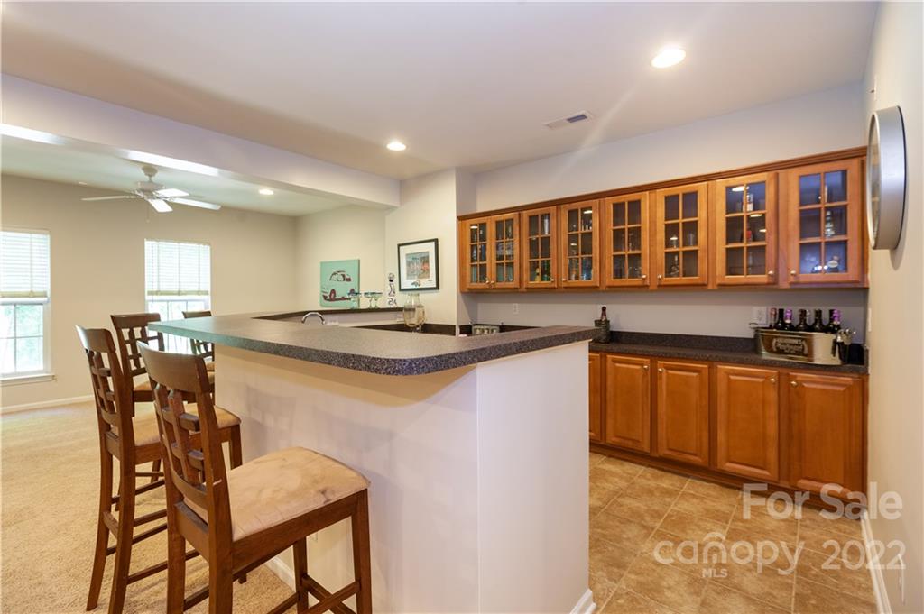 1292 Valhalla Drive Denver, NC 28037 - Photo 37 of 47 a kitchen with stainless steel appliances granite countertop a stove top oven a sink a dining table and chairs