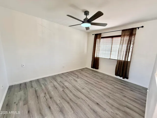 wooden floor in an empty room with a window