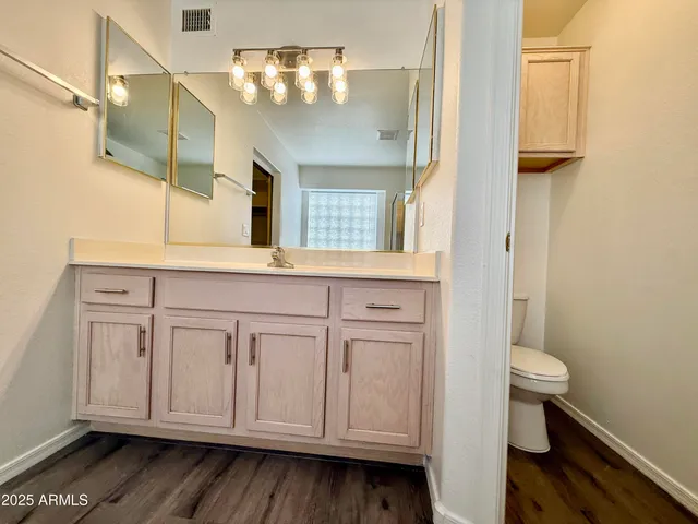 a bathroom with a sink a toilet and mirror