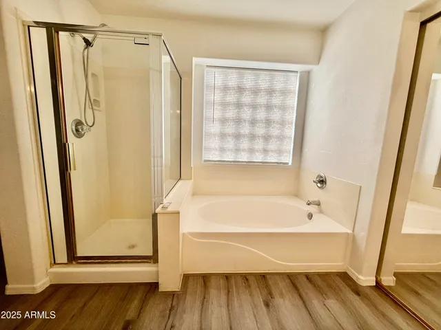 a bathroom with a bathtub and a shower
