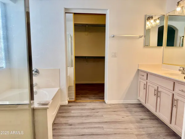 a view of walk in closet with wooden floor