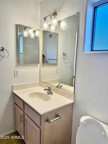 a bathroom with a sink vanity and a mirror