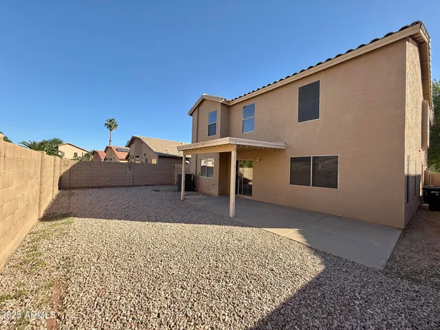 a view of a house with a backyard
