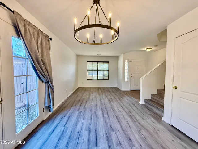 a view of an entryway with wooden floor and door