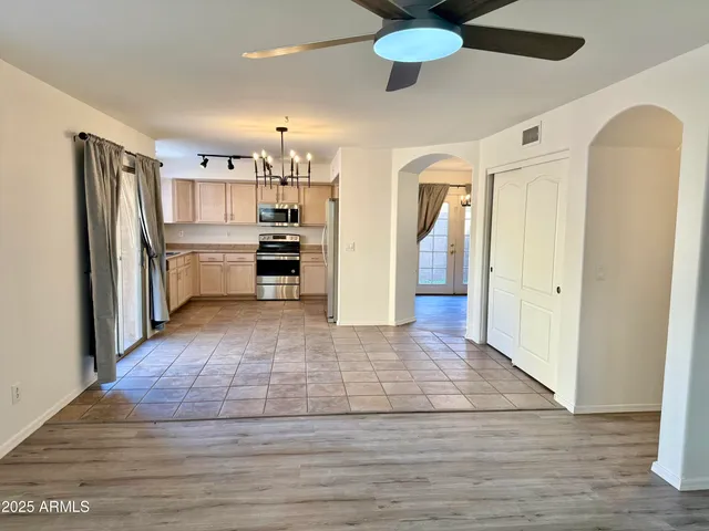 a view of a kitchen with a sink refrigerator and wooden floor