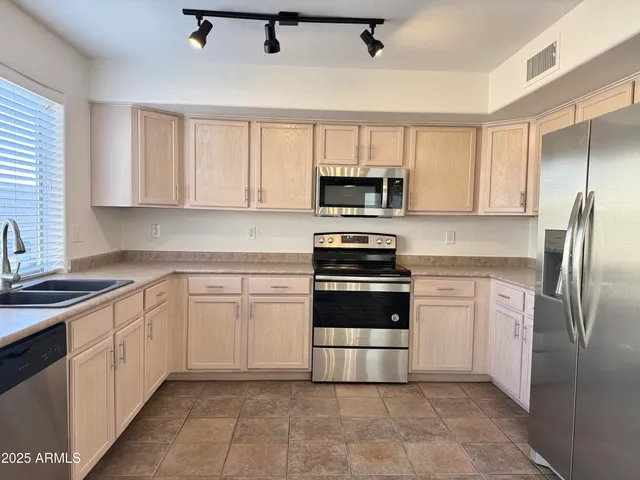 a kitchen with a sink appliances and cabinets
