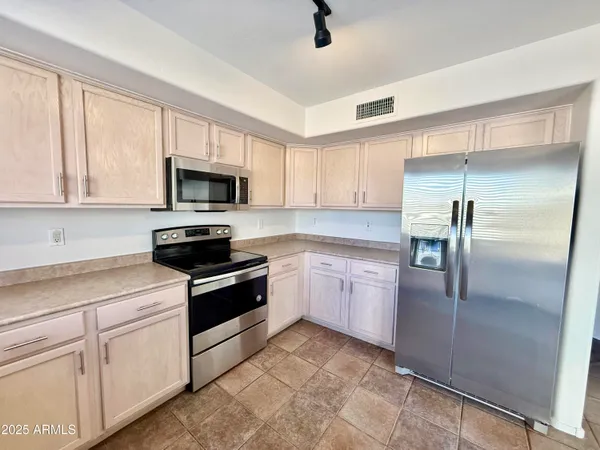 a kitchen with a refrigerator stove and microwave