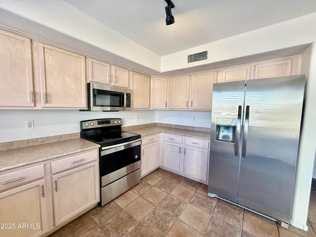 a kitchen with a refrigerator stove and microwave