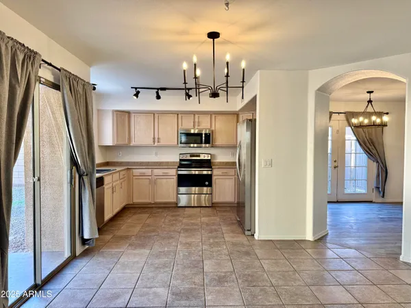 a kitchen with stainless steel appliances a refrigerator sink and microwave
