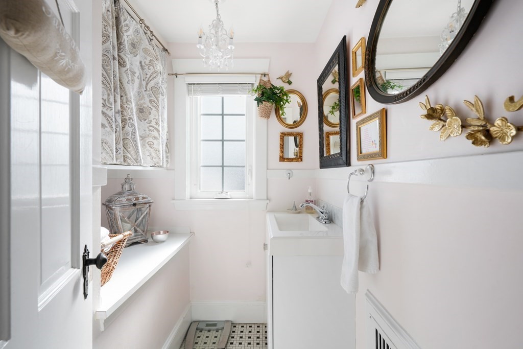 63 Standish Road Milton, MA 02186 - Photo 13 of 38 a bathroom with a sink a mirror a window and a shower